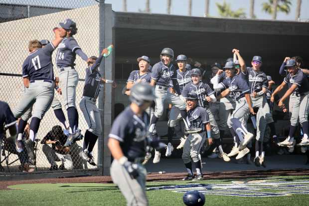 Vista Murrieta players celebrate after designated hitter Vaughn Neckar, far...