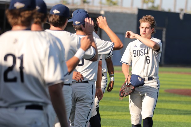 St. John Bosco freshman reliever Brayden Krakowski is greeted by...