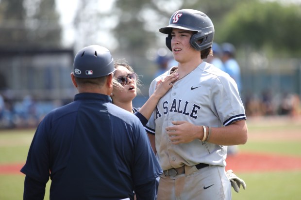 La Salle’s Pete Callihan has his shoulder looked at by...