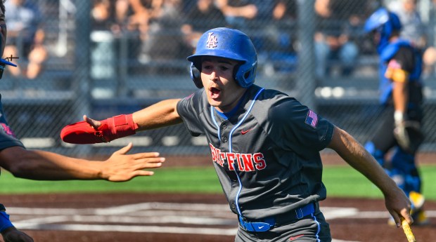 Los Alamitos’ Logan Wyler (4) reacts after scoring against La...