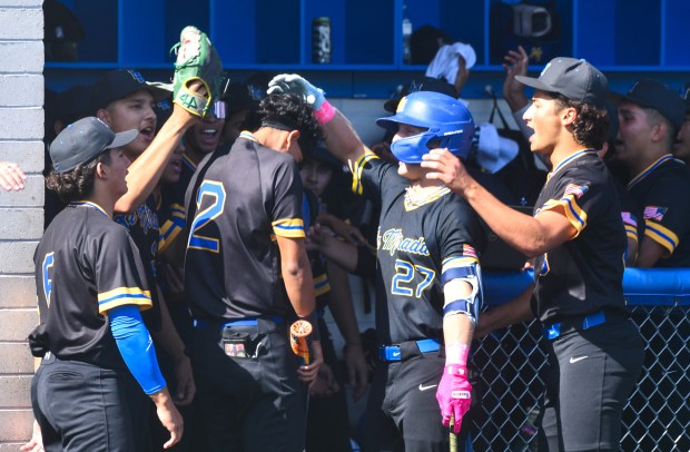 La Mirada players congratulate Michael Burgueno (2) after scoring against...