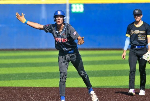 Los Alamitos’ Damon Valdez (16) reacts after hitting a double...