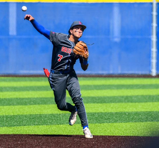 Los Alamitos shortstop Tyler Smith (7) makes a diving stop...