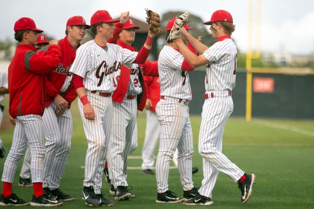 Redwood players celebrate their 3-0 victory over San Rafael in...