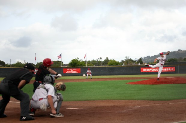 Redwood pitcher Matthew Knauer (6) delivers against San Rafael during...