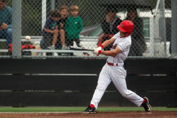 Redwood’s Chase Johnson (13) connects for an RBI single against...