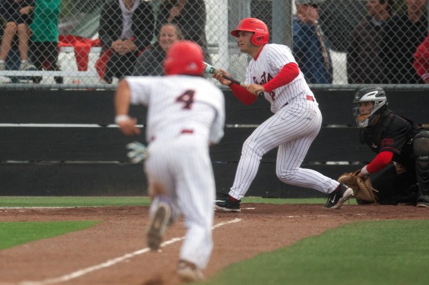 Redwood designated hitter Miles Harrison (8) squares to bunt on...
