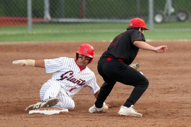 Redwood’s Theo Trono (4) slides safely into second base with...
