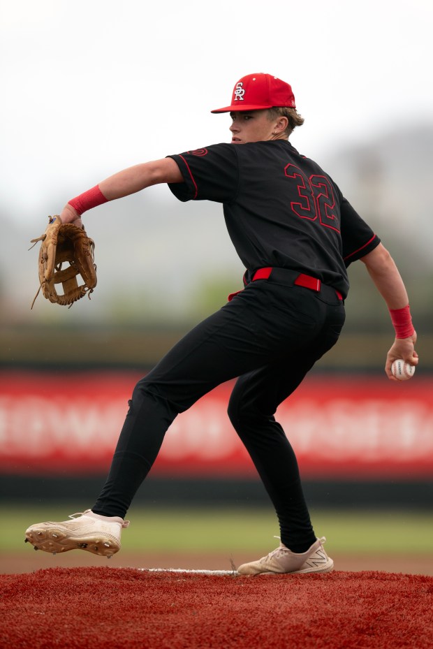 San Rafael starting pitcher Colby Jackson (13) warms up before...