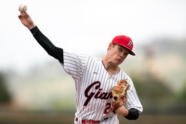 Redwood starting pitcher Jack Gurley (23) warms up before the...