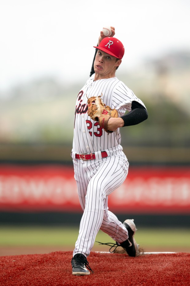 Redwood starting pitcher Jack Gurley (23) warms up before the...