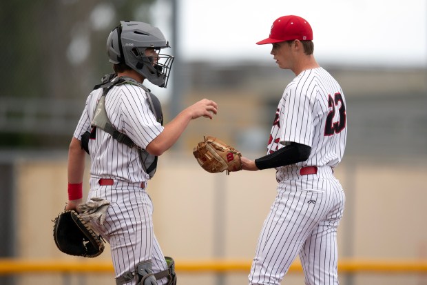 Redwood battery Ethan Ferry (7) and Jack Gurley (23) confer...