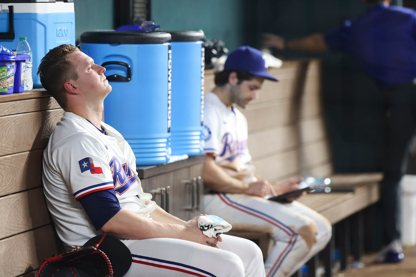 Texas Rangers pitcher Jacob Webb sits dejected in the dug out after falling short against...