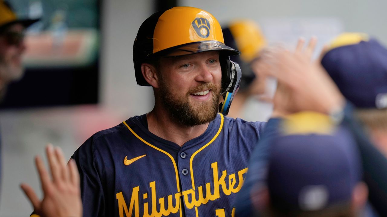Milwaukee Brewers' Rhys Hoskins is congratulated in the dugout after hitting a home run in the seventh inning of a baseball game against the Cleveland Guardians in Cleveland, Wednesday, May 14, 2025.