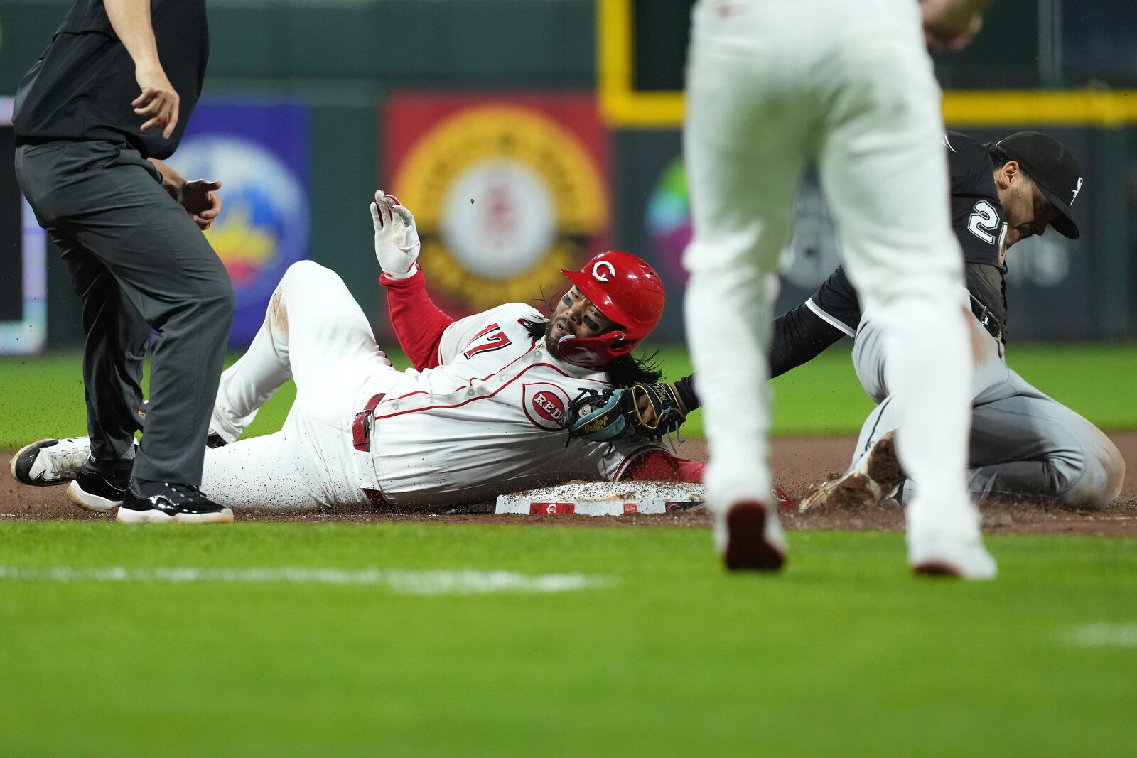 Cincinnati Reds' Connor Joe is tagged out stealing third base by Chicago White Sox's Miguel Vargas in the eighth inning of a baseball game Tuesday, May 13, 2025, in Cincinnati. (AP Photo/Kareem Elgazzar)