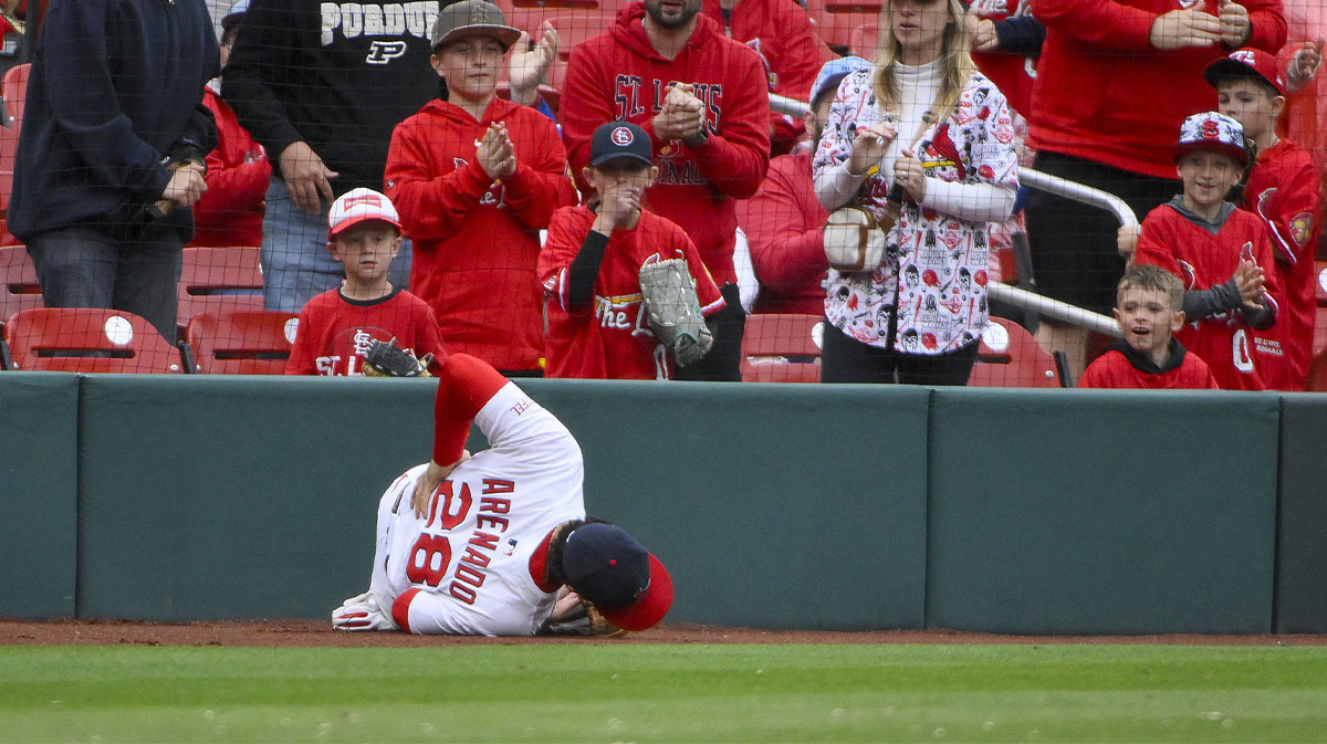 St. Louis Cardinals third baseman Nolan Arenado (28) lays on the warning track after falling in to the crowd catching a foul ball hit by Arizona Diamondbacks second baseman Ketel Marte (not pictured) during the ninth inning at Busch Stadium.
