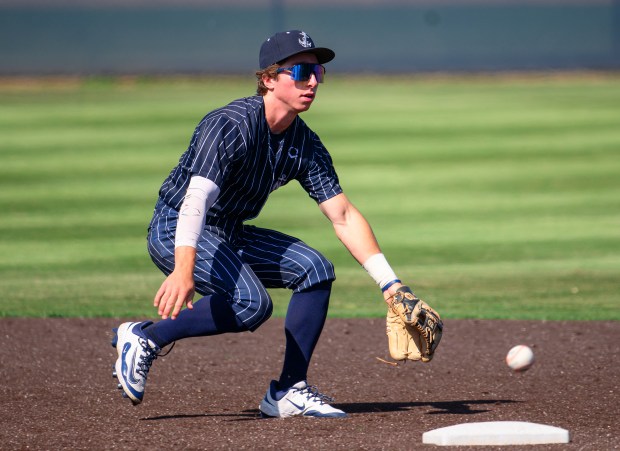 Newport Harbor shortstop Adam Martin doesn’t get to ground ball...