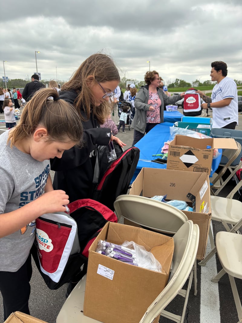 Volunteers assemble hygiene kits at a tailgate as part of the JustServe night at the Kansas City Royals Major League Baseball game April 25, 2025, in Kansas City, Missouri.
