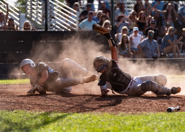 Pleasant Valley’s Colton Fleck (left) is called safe at home...