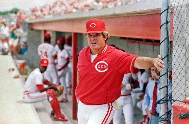 FILE - In this March 22, 1989, file photo, Cincinnati Reds' manager Pete Rose leans against the dugout fence before the start of baseball game in Plant City, Fla. (AP Photo/John Swart, File)