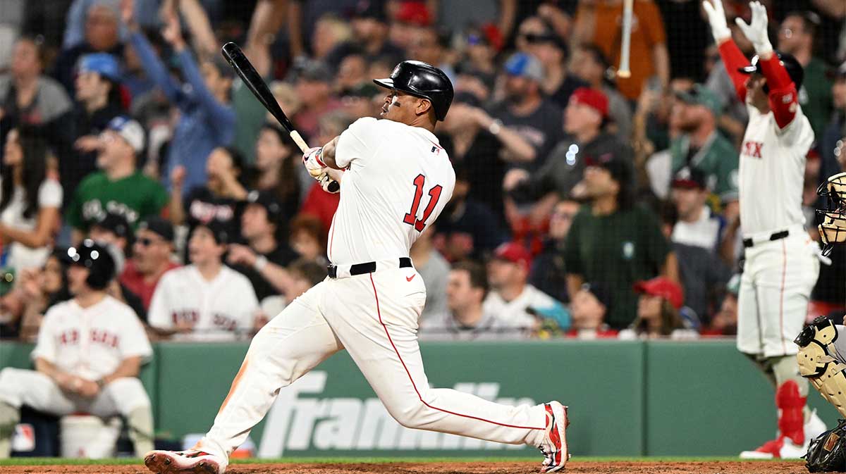 Boston Red Sox designated hitter Rafael Devers (11) hits a walk off home run against the Atlanta Braves during the ninth inning at Fenway Park.