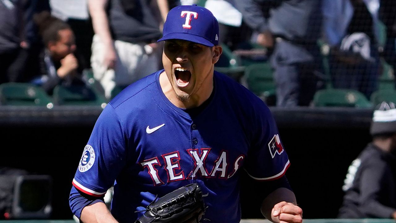 Texas Rangers pitcher Robert Garcia (62) celebrates after getting the final out against the Chicago White Sox during the ninth inning of a baseball game Sunday, May 25, 2025, in Chicago. (AP Photo/David Banks)