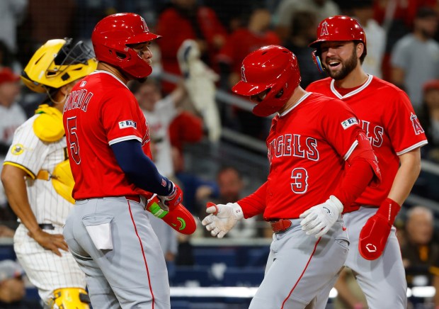 Los Angeles Angels' Taylor Ward (3) celebrates with Yoán Moncada, left, and Nolan Schanuel after hitting a grand slam off of San Diego Padres' Alek Jacob in the ninth inning at Petco Park on Monday, May 12, 2025. (K.C. Alfred / The San Diego Union-Tribune)