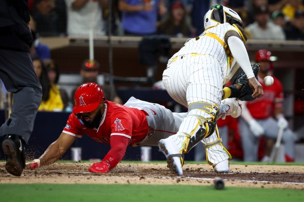 Los Angeles Angels second baseman Luis Rengifo slides safely across home plate against San Diego Padres catcher Martin Maldonado during the seventh inning at Petco Park on Tuesday, May 13, 2025 in San Diego, CA. (Meg McLaughlin / The San Diego Union-Tribune)