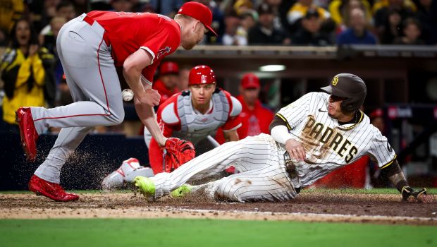 San Diego Padres third baseman Manny Machado slides safely across home plate against Los Angeles Angels relief pitcher Ryan Zeferjahn during the eighth inning at Petco Park on Tuesday, May 13, 2025 in San Diego, CA. (Meg McLaughlin / The San Diego Union-Tribune)