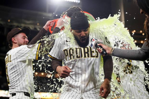 San Diego Padres center fielder Jackson Merrill and center fielder Tyler Wade douse right fielder Fernando Tatis Jr. in sports drink after his game-win ing home run against the Los Angeles Angels at Petco Park on Tuesday, May 13, 2025 in San Diego, CA. (Meg McLaughlin / The San Diego Union-Tribune)