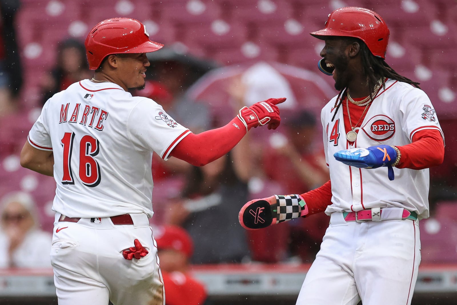 Cincinnati Reds' Noelvi Marte (16) celebrates with teammate Elly De La Cruz, right, after scoring on a single hit by Santiago Espinal during the seventh inning of a baseball game the St. Louis Cardinals, Thursday, May 1, 2025, in Cincinnati. (AP Photo/Abdoul Sow)