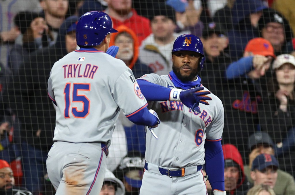 Starling Marte (right), slaps hands with Tyrone Taylor after Taylor scored a run in the seventh inning of the Mets' 5-1 win over the Red Sox on May 21, 2025.