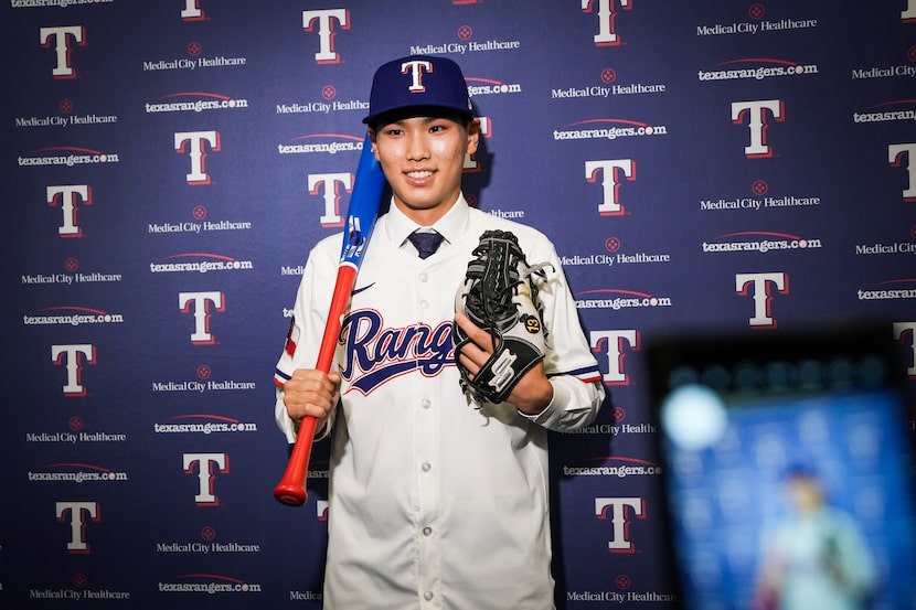 Texas Rangers international free agent signee Seong-Jun Kim from South Korea poses for...
