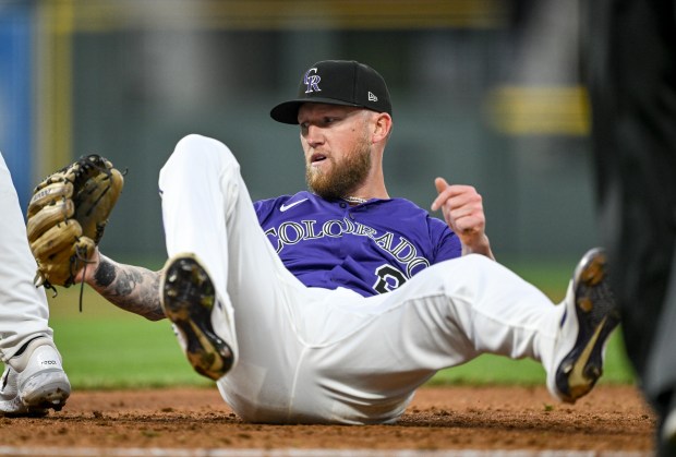 Kyle Freeland (21) of the Colorado Rockies falls to the ground after Michael Toglia (4) make a force out of Brice Turang (2) of the Milwaukee Brewers at first base during the third inning at Coors Field in Denver on Tuesday, April 8, 2025. (Photo by AAron Ontiveroz/The Denver Post)