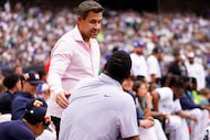 Former Seattle Mariner Bret Boone, facing, greets former Mariner Ken Griffey, Jr., during...