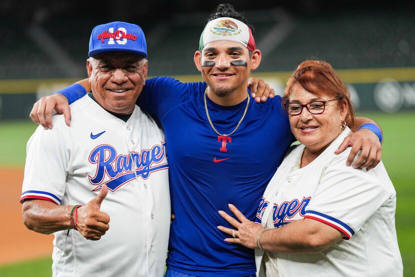 Texas Rangers outfielder Alejandro Osuna poses for a photo with his father Roberto Osuna and...