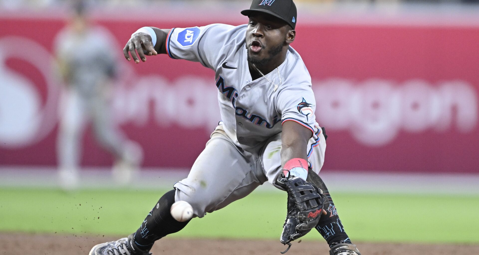 Miami Marlins second baseman Ronny Simon (41) canÕt make the stop on a ball hit by San Diego Padres shortstop Xander Bogaerts (2) during the third inning at Petco Park. Simon was charged with an error on the play.