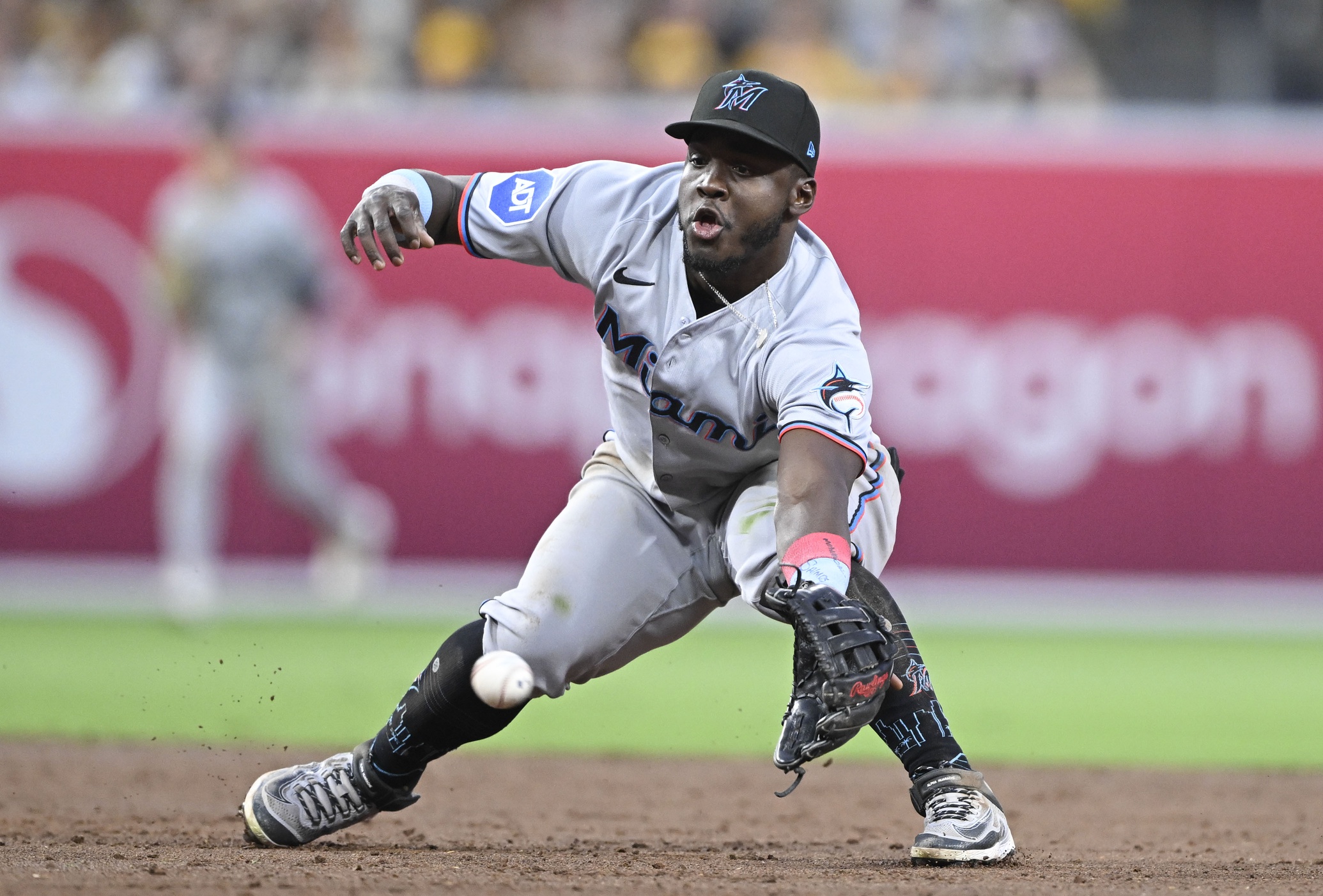 Miami Marlins second baseman Ronny Simon (41) canÕt make the stop on a ball hit by San Diego Padres shortstop Xander Bogaerts (2) during the third inning at Petco Park. Simon was charged with an error on the play.