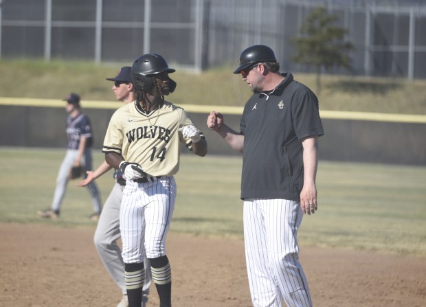 American Canyon's Cole Gholar fist bumps the first base coach after hitting a single in the Wolves' 3-1 victory over Stuart Hall in the first round of the North Coast Section Division III playoffs on Wednesday. (Jahson Nahal/Times-Herald)