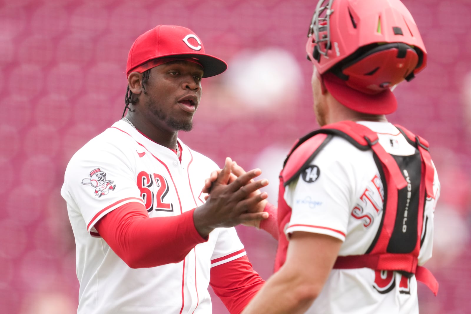 Cincinnati Reds' Luis Mey (62) celebrates with teammate Tyler Stephenson following a baseball game against the Chicago White Sox, Thursday, May 15, 2025, in Cincinnati. (AP Photo/Jeff Dean)