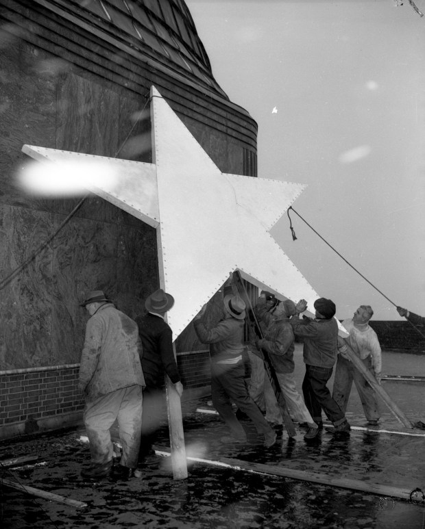 Chicago Park District workers place a star on the front...