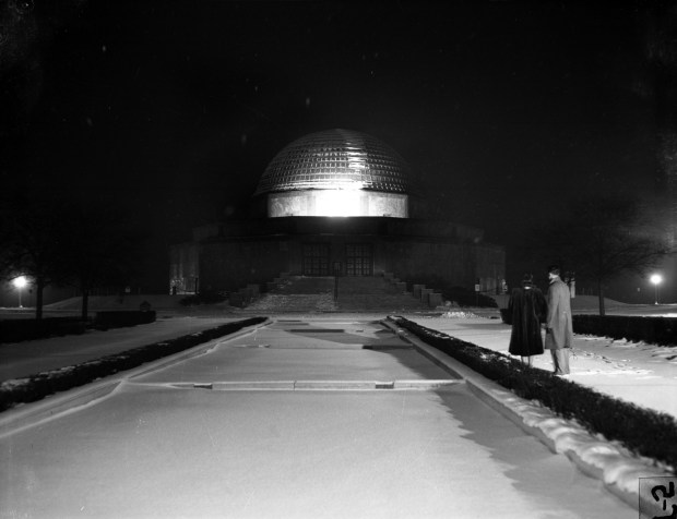 A Christmas star lights up the Adler Planetarium at night...