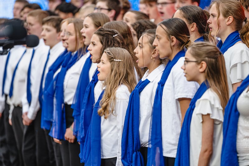 An interfaith children's choir sings the national anthem at the Kansas City Royals Major League Baseball game as part of a JustServe night April 25, 2025, in Kansas City Missouri.