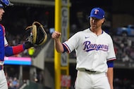 Texas Rangers starting pitcher Jacob deGrom, right, reaches out to teammate catcher Jonah...