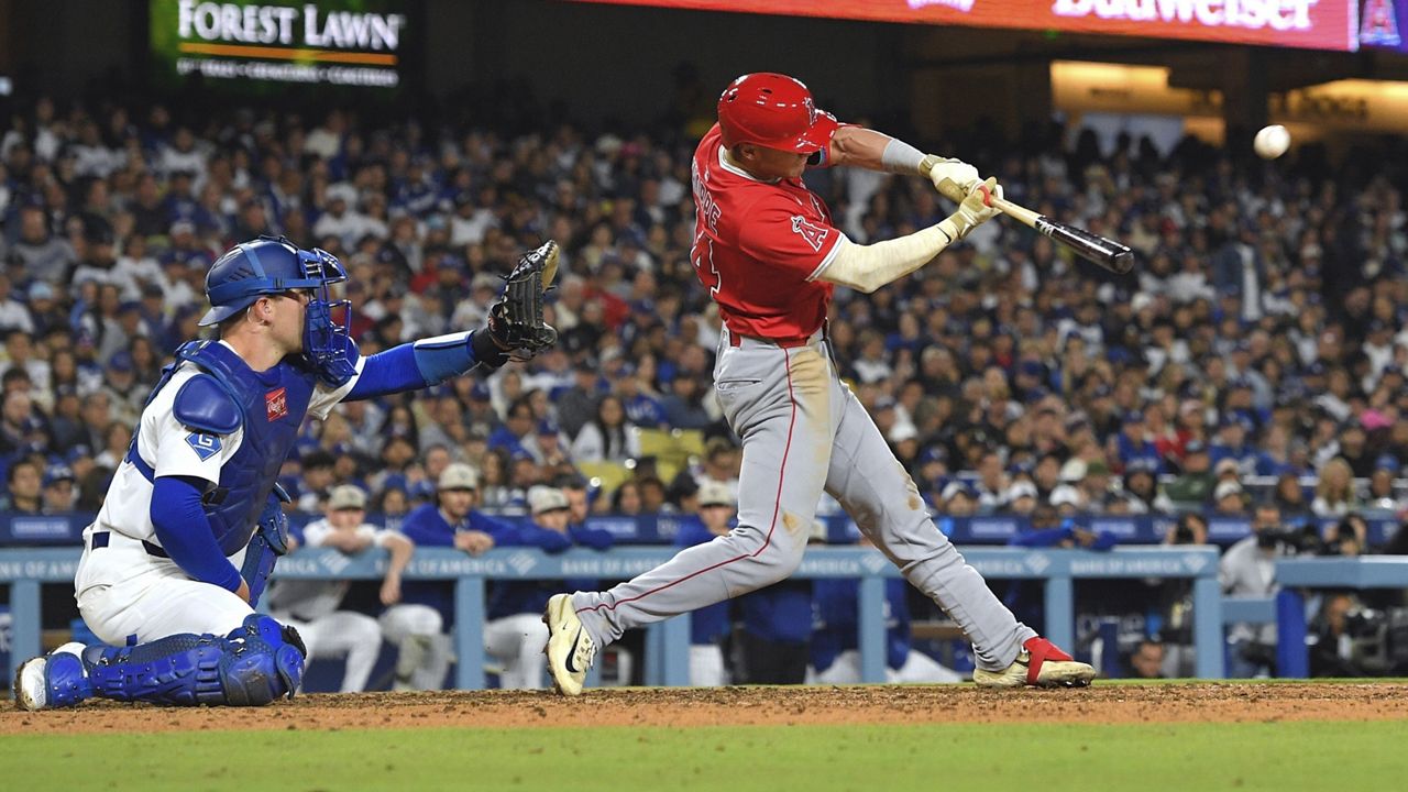 Los Angeles Angels' Logan O'Hoppe, hits a three-run home run as Los Angeles Dodgers catcher Dalton Rushing watches during the seventh inning of a baseball game Saturday, May 17, 2025, in Los Angeles. (AP Photo/Mark J. Terrill)