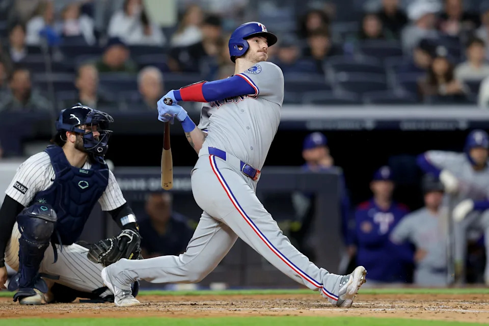 May 20, 2025; Bronx, New York, USA; Texas Rangers catcher Jonah Heim (28) follows through on a double against the New York Yankees during the fifth inning at Yankee Stadium.