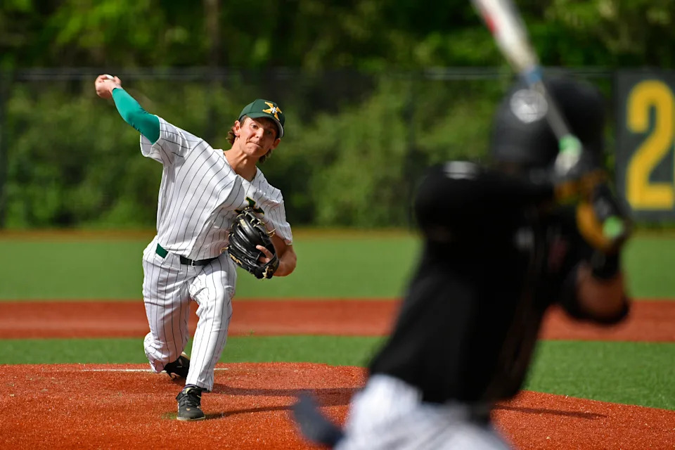 St. Xavier's Jakob Reed pitches to Ballard during their game May 1.