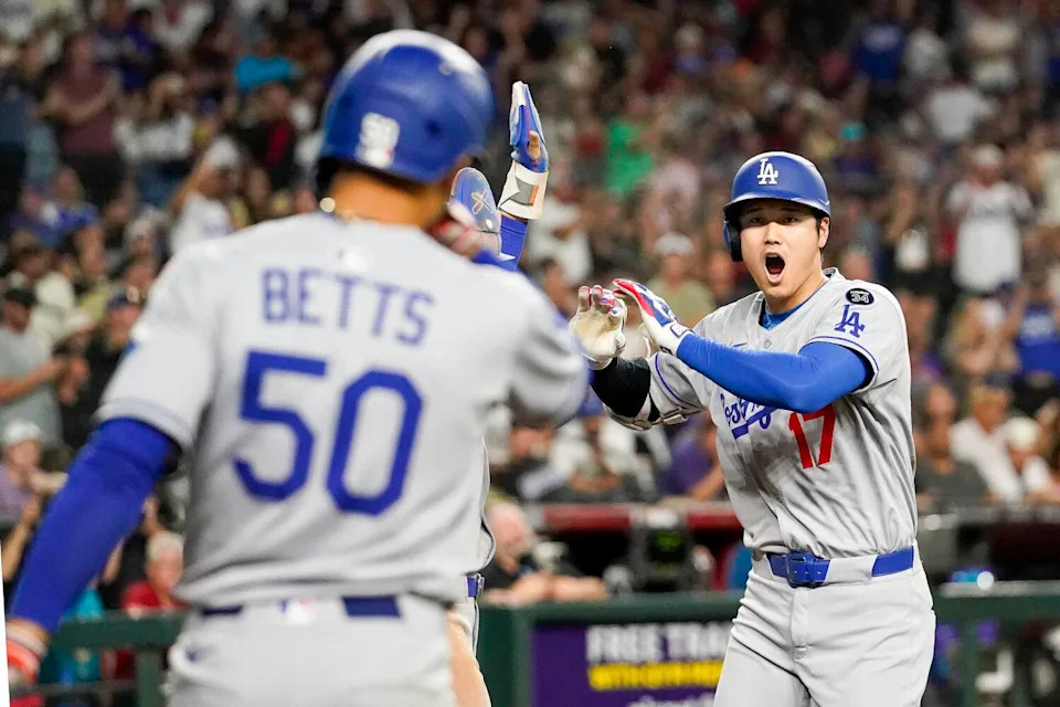 Shohei Ohtani holds out his hands after hitting a three-run home run in the ninth inning against Arizona on Friday.