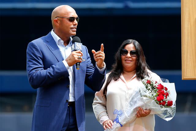 Jim McIsaac/Getty Mariano Rivera speaks at Yankee Stadium in August 2019 while next to his wife, Clara