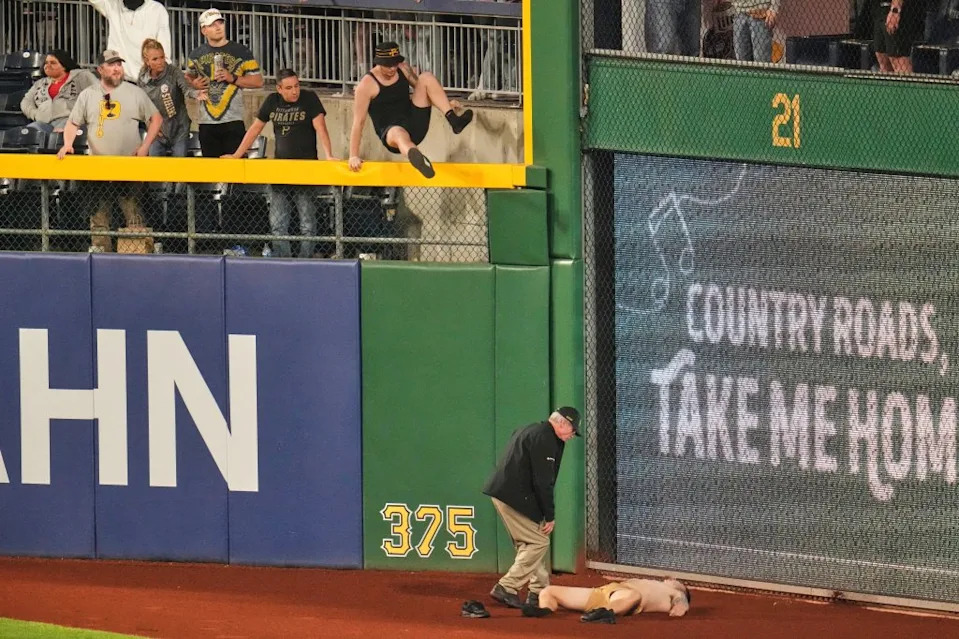 A fan lies on the warning track in right field of PNC Park after falling out of the stands during the seventh inning of a baseball game between the Pittsburgh Pirates and the Chicago Cubs in Pittsburgh, Wednesday, April 30, 2025. AP